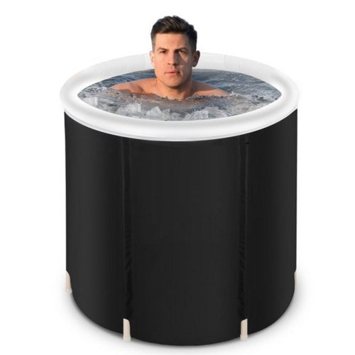 A man sitting shoulder-deep in the RIME One filled with ice water